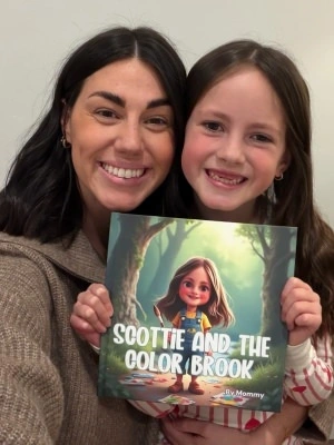Child holding a personalized book with a big smile
